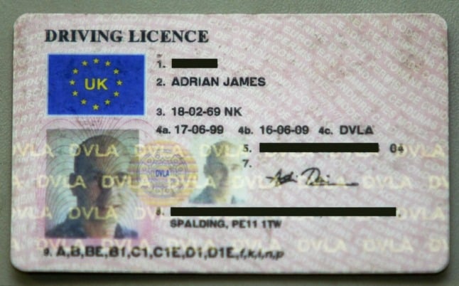 UK driving licence photocard. (Photo by ADRIAN DENNIS / AFP)